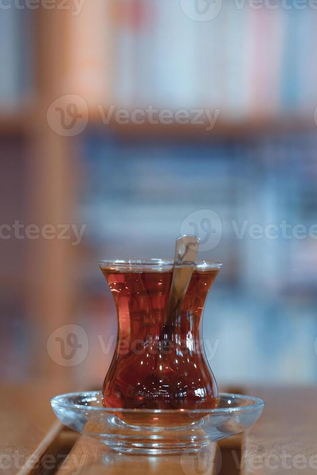 Traditional Turkish Tea in Thin Belly Glass, Library Setting photo