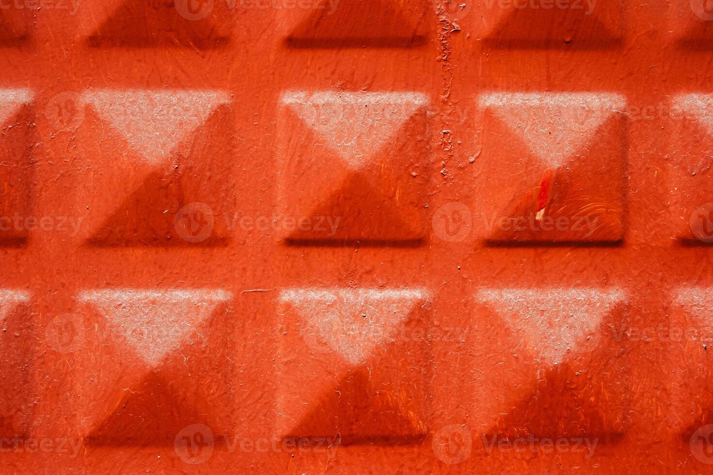 Close up of a terracotta textured surface with a geometric pattern of raised squares, texture, background. photo