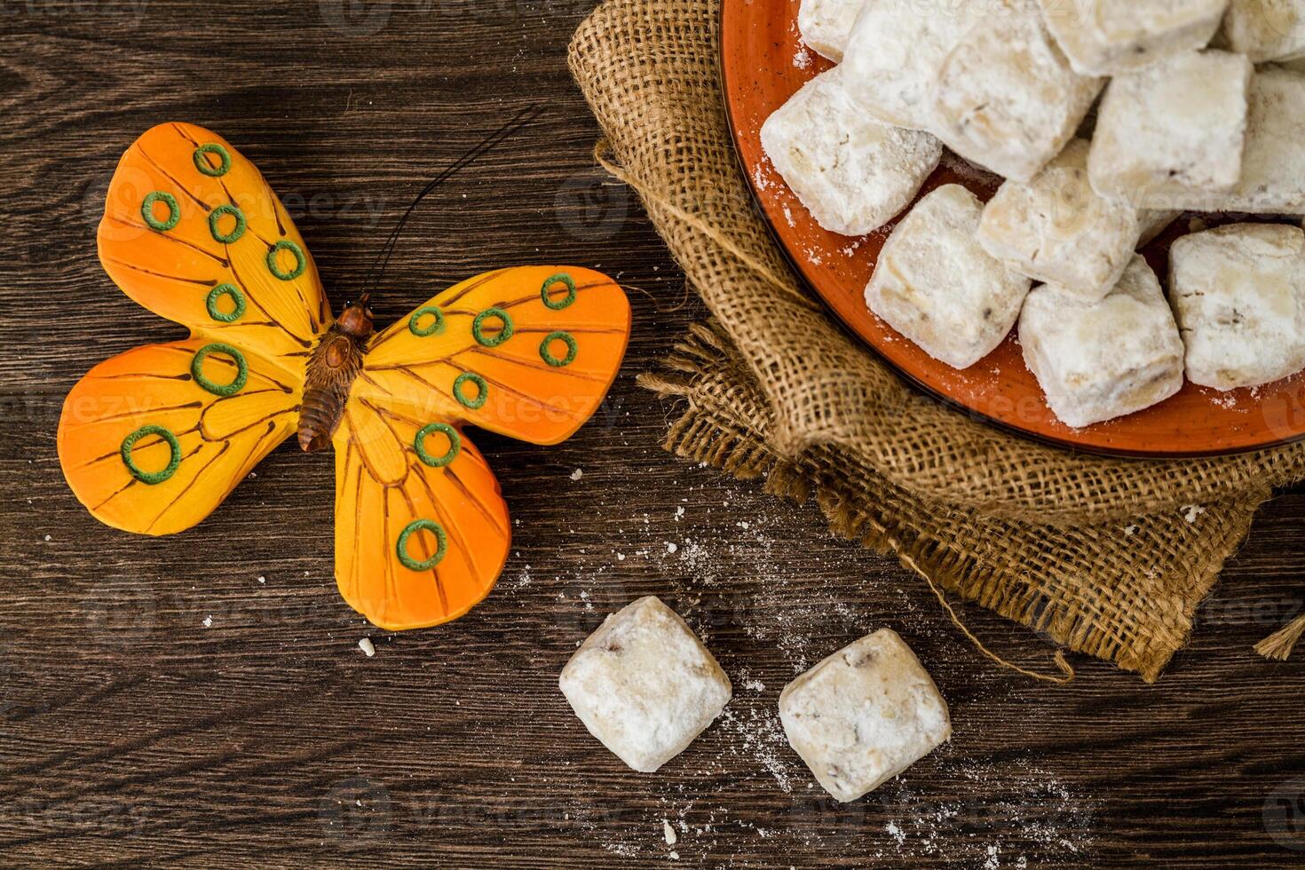 Homemade almond cookies with butter in orange plate. photo