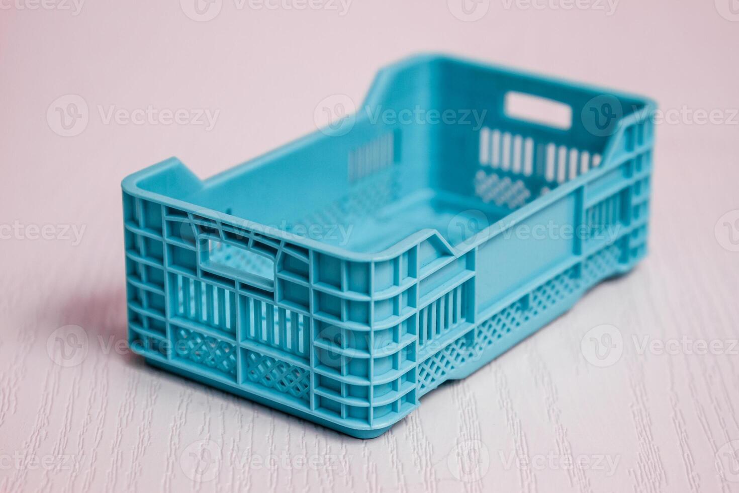 Single Light Blue Plastic Crate, Pink Background photo