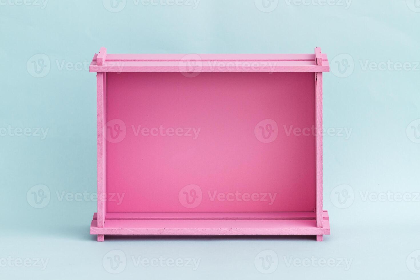 Vibrant Pink Wooden Box Against Light Blue Background, Minimalist Design photo