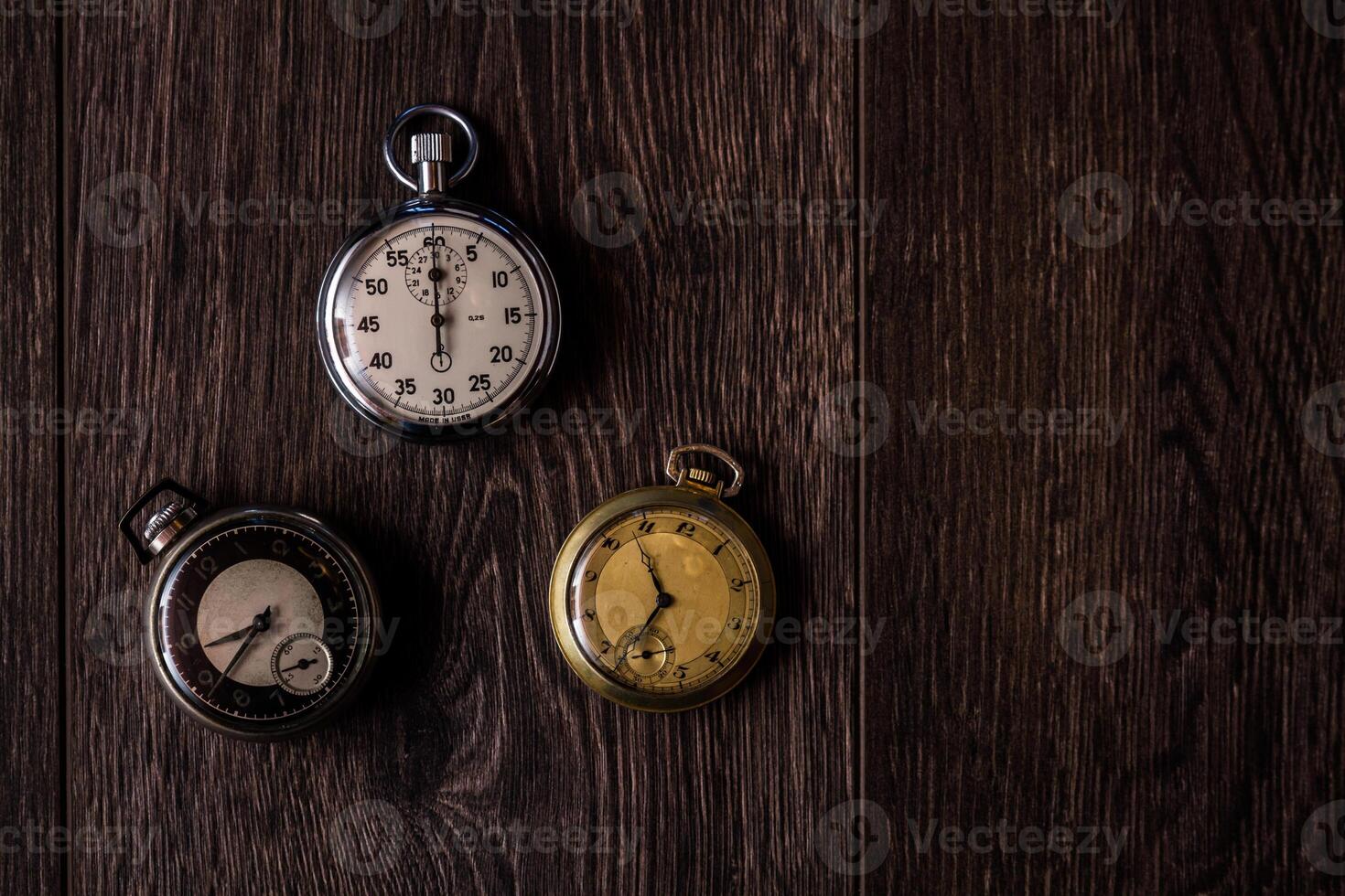 Collection of Antique Pocket Watches with Various Designs on Wooden Background photo