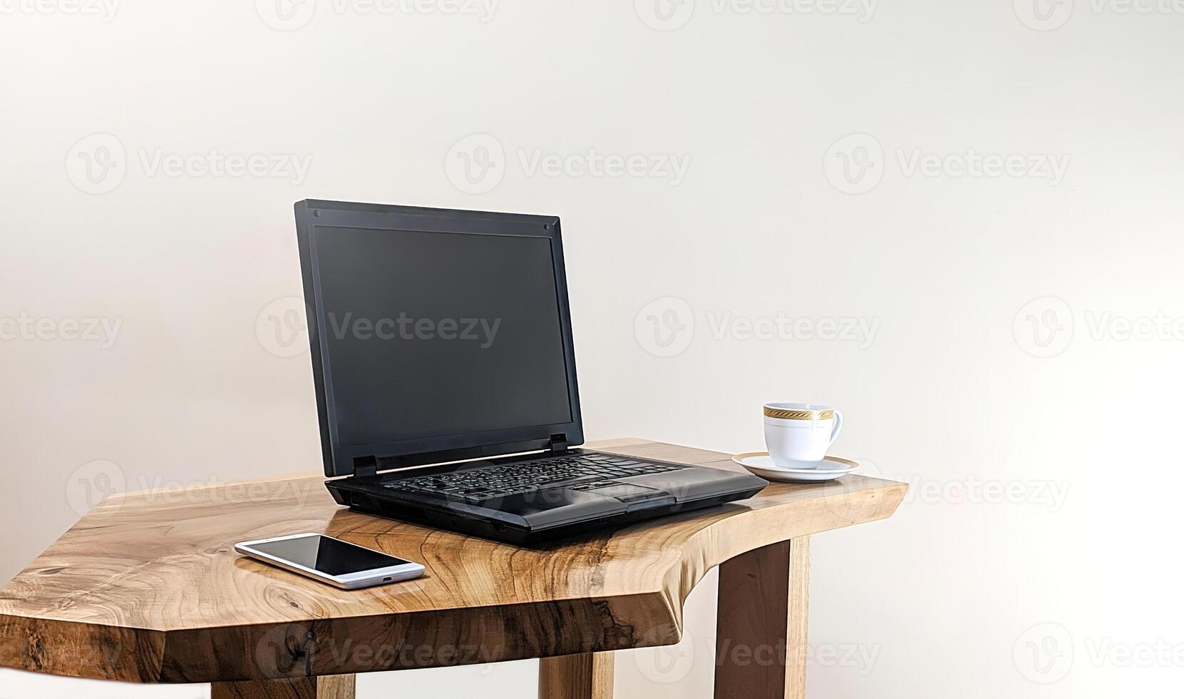 Mockup of laptop computer with empty screen with coffee cup and smartphone on table of the coffee shop background,White background photo