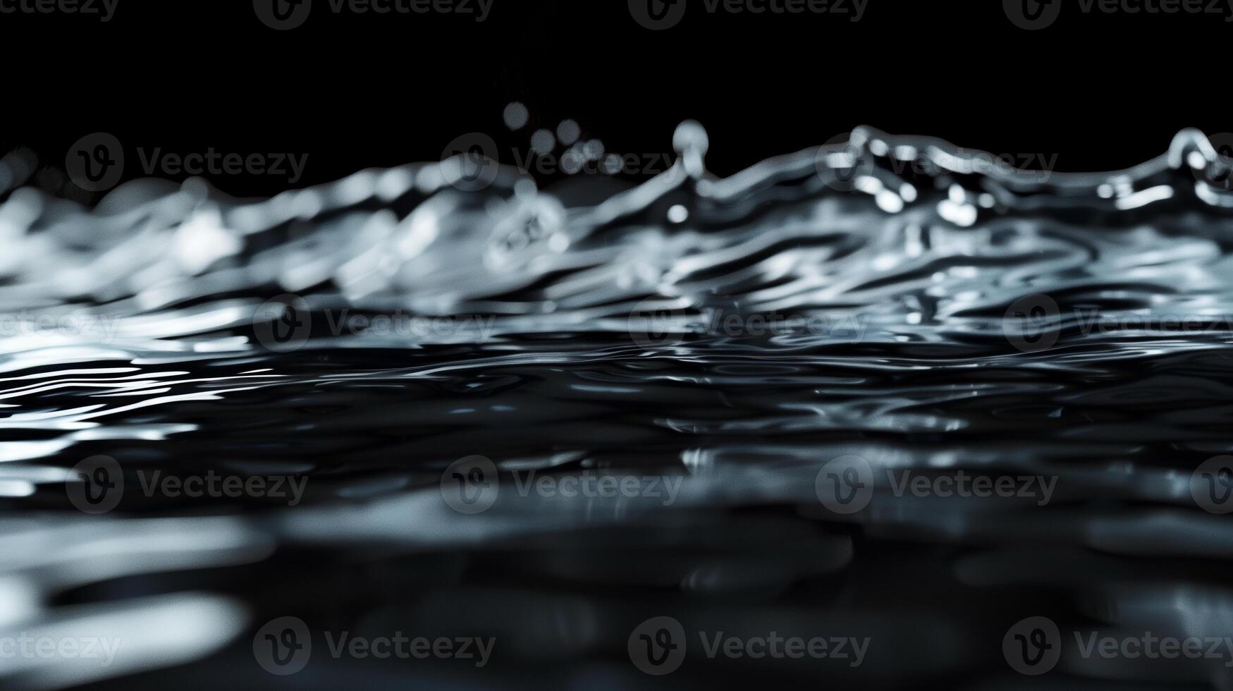 A close up of the water surface with the waves on the black background. photo