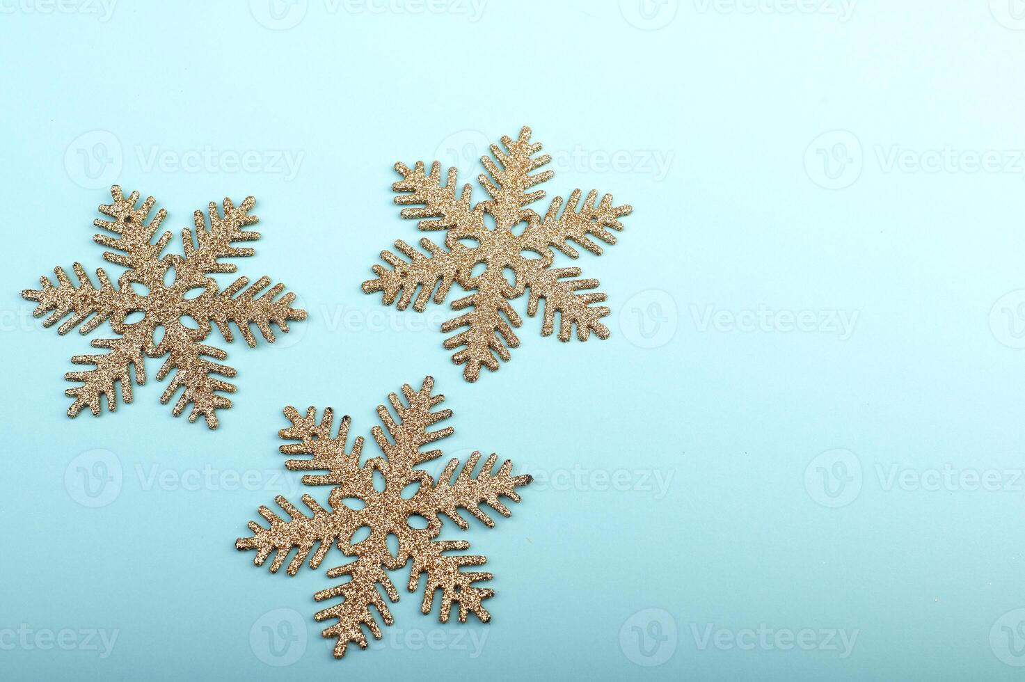 Golden snowflakes on a pastel green background photo