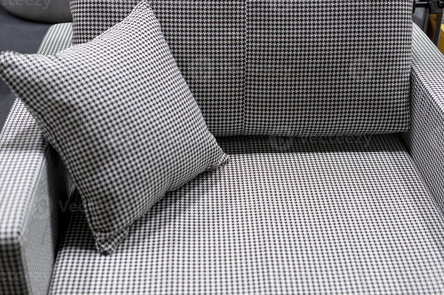 small sofa with a stylish pillow, variegated fabric in black and white tones photo