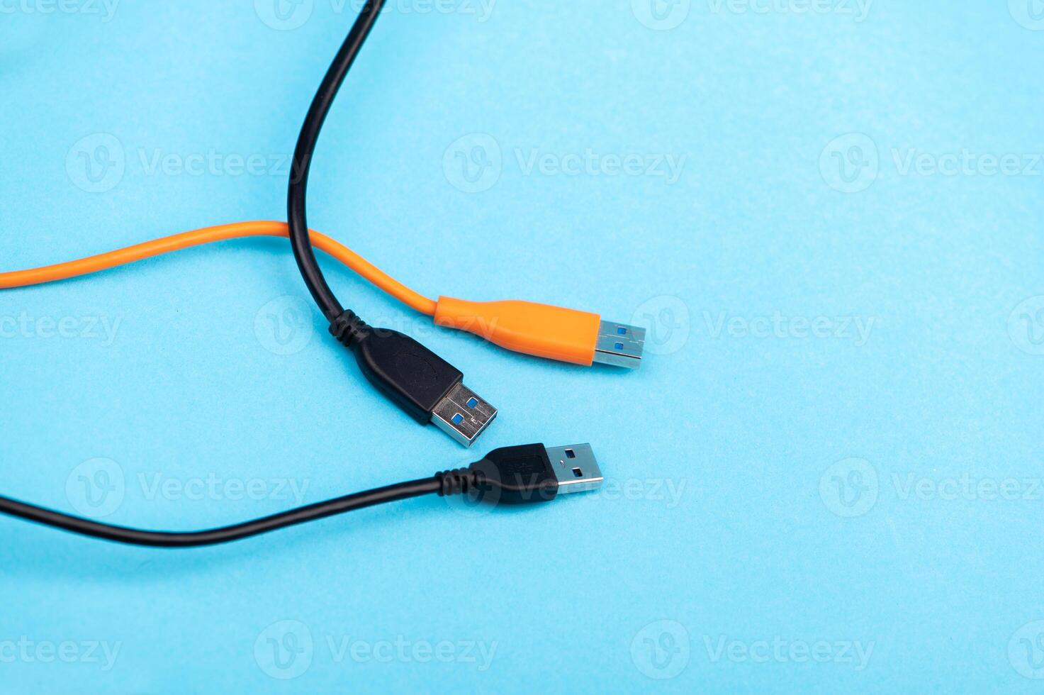 Multicolored computer cable USB isolated on blue background photo