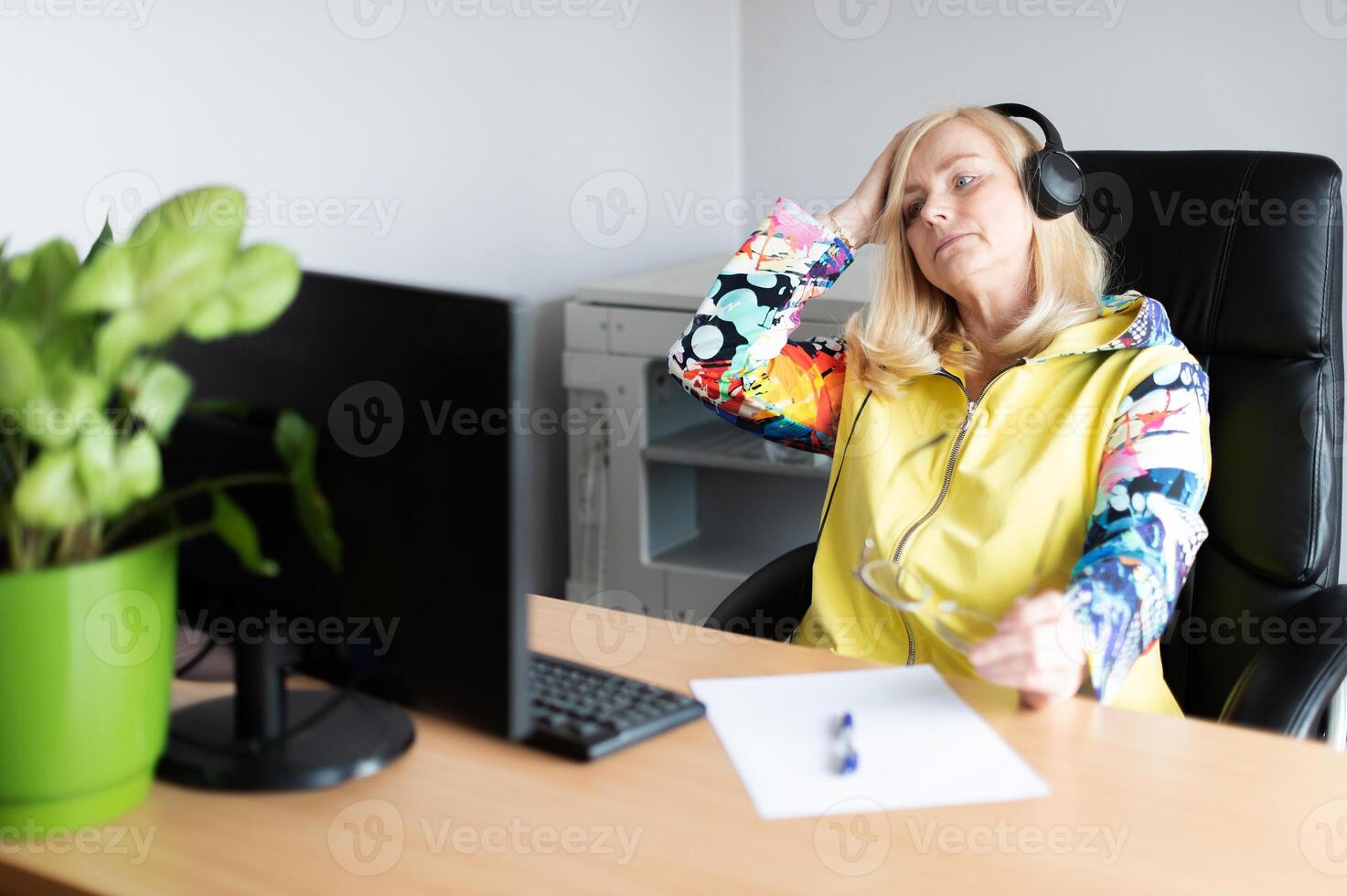 Middle aged tired, stressed and frustrated business woman desperate working at office with computer photo