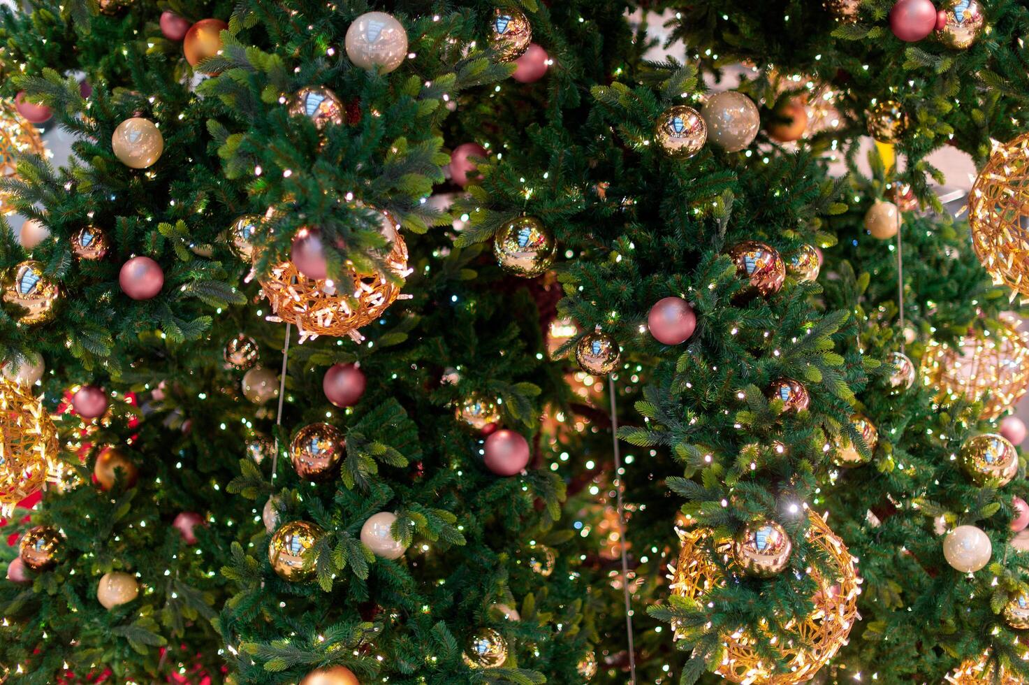 Gold Christmas background of de-focused lights with decorated tree. decorated Christmas tree with golden toys photo