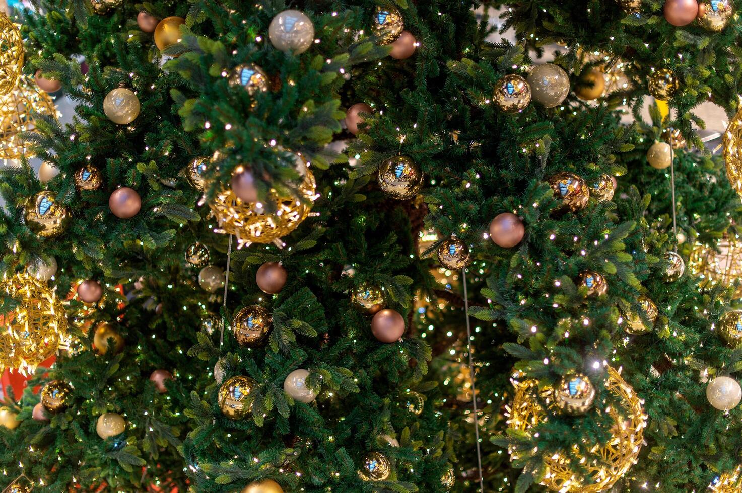 Gold Christmas background of de-focused lights with decorated tree. decorated Christmas tree with golden toys photo