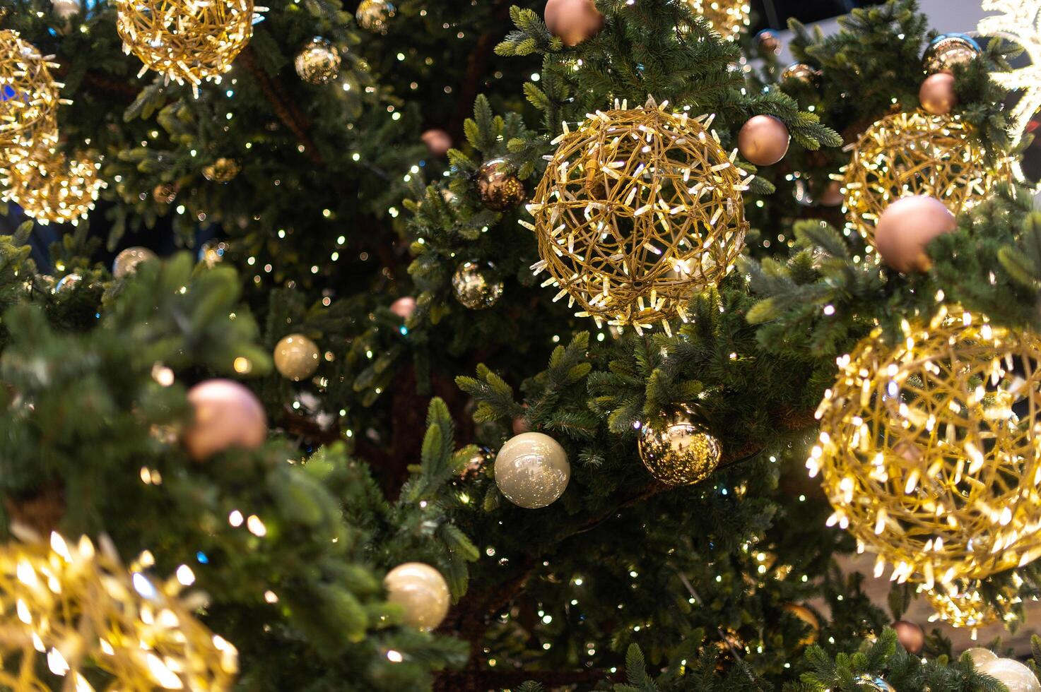 Gold Christmas background of de-focused lights with decorated tree. decorated Christmas tree with golden toys photo