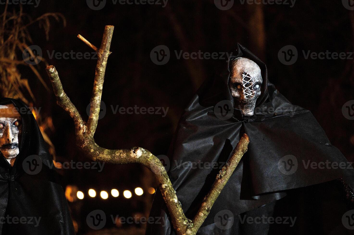 Spooky Halloween decoration stands in a wooded area creating a sinister atmosphere photo