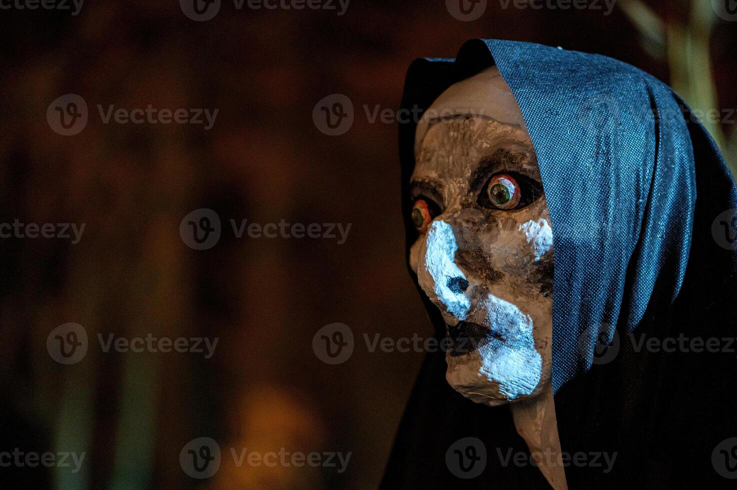 Spooky Halloween decoration stands in a wooded area creating a sinister atmosphere photo