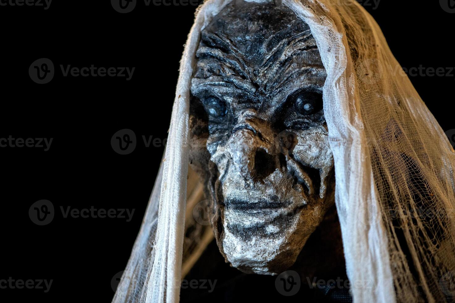 Spooky Halloween decoration stands in a wooded area creating a sinister atmosphere photo