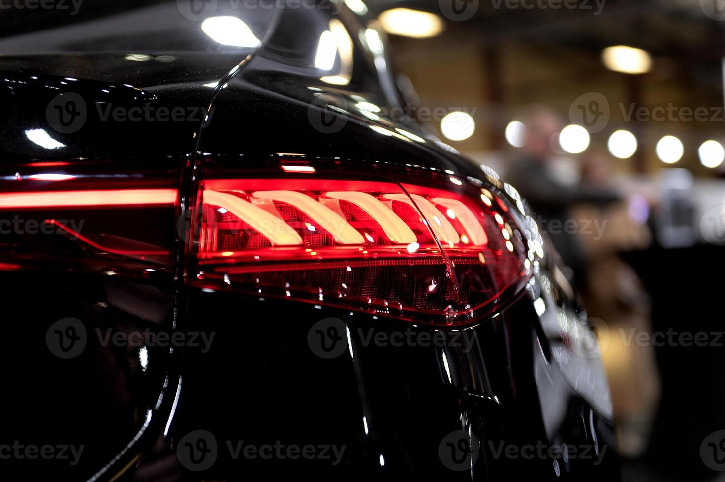Closeup of a modern car s LED red taillight signaling turning on street to maintain distance with a closeup of the trunk photo
