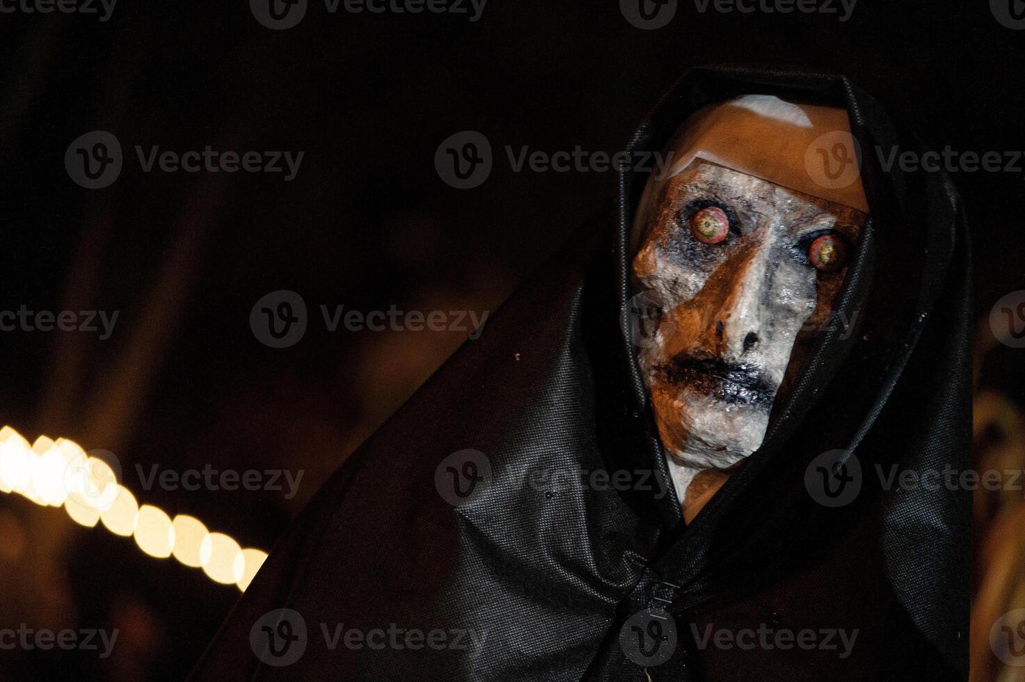 Spooky Halloween decoration stands in a wooded area creating a sinister atmosphere photo