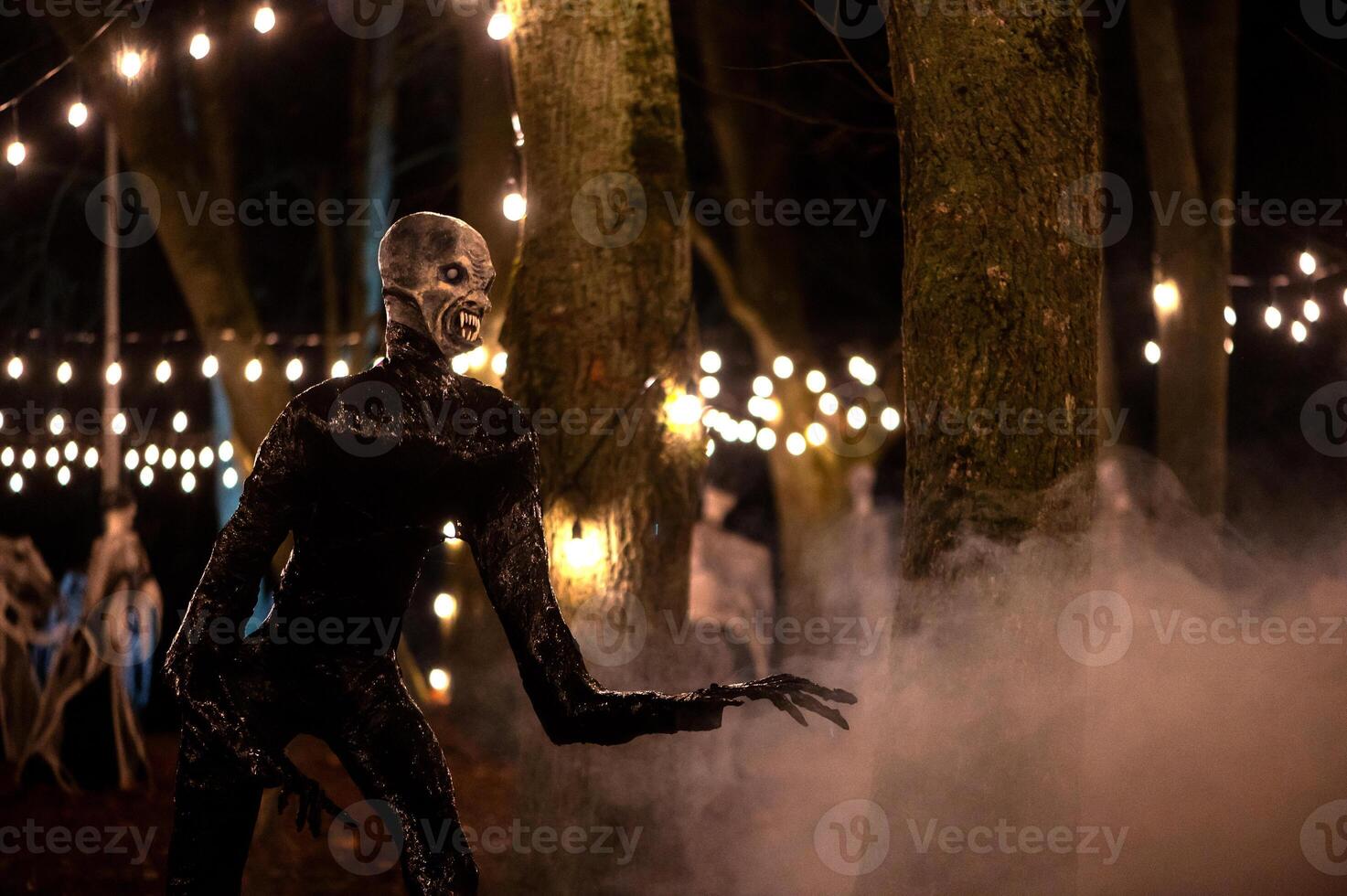 Spooky Halloween decoration stands in a wooded area creating a sinister atmosphere photo