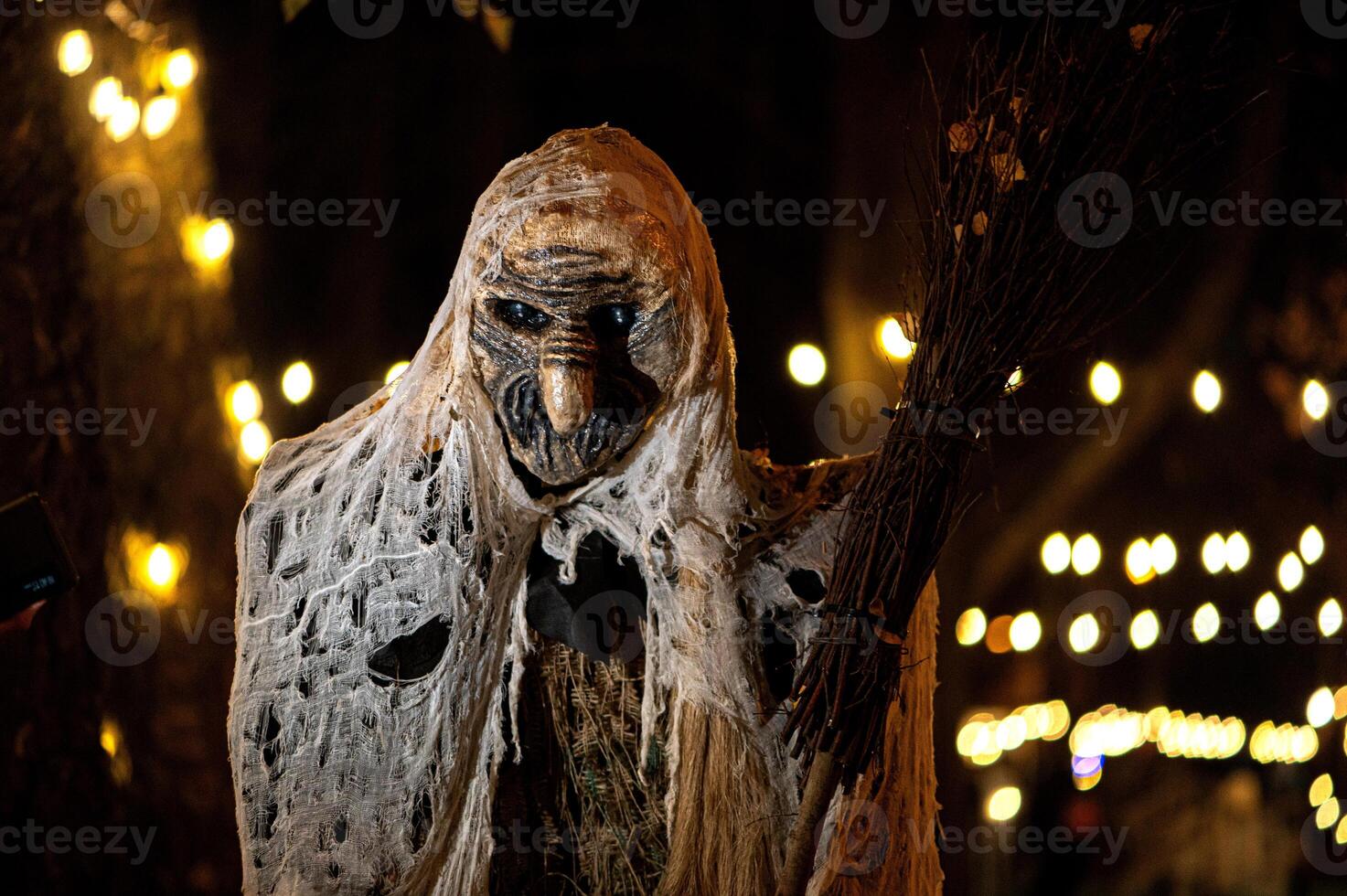 Spooky Halloween decoration stands in a wooded area creating a sinister atmosphere photo