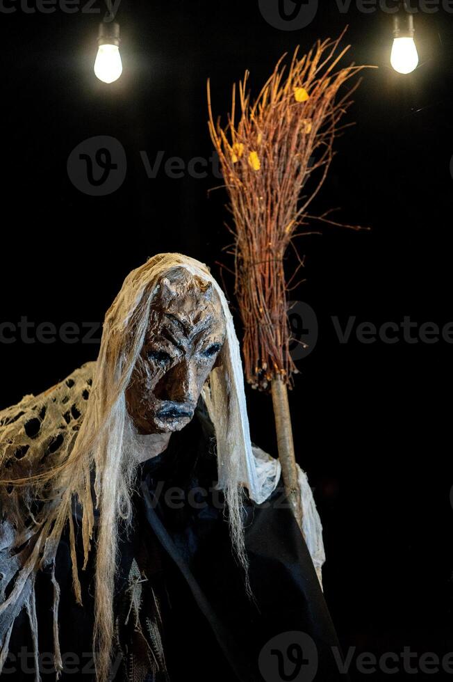 Spooky Halloween decoration stands in a wooded area creating a sinister atmosphere photo