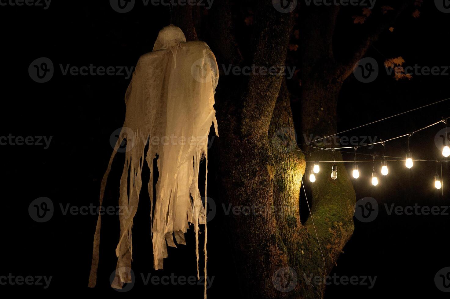 Spooky Halloween decoration stands in a wooded area creating a sinister atmosphere photo