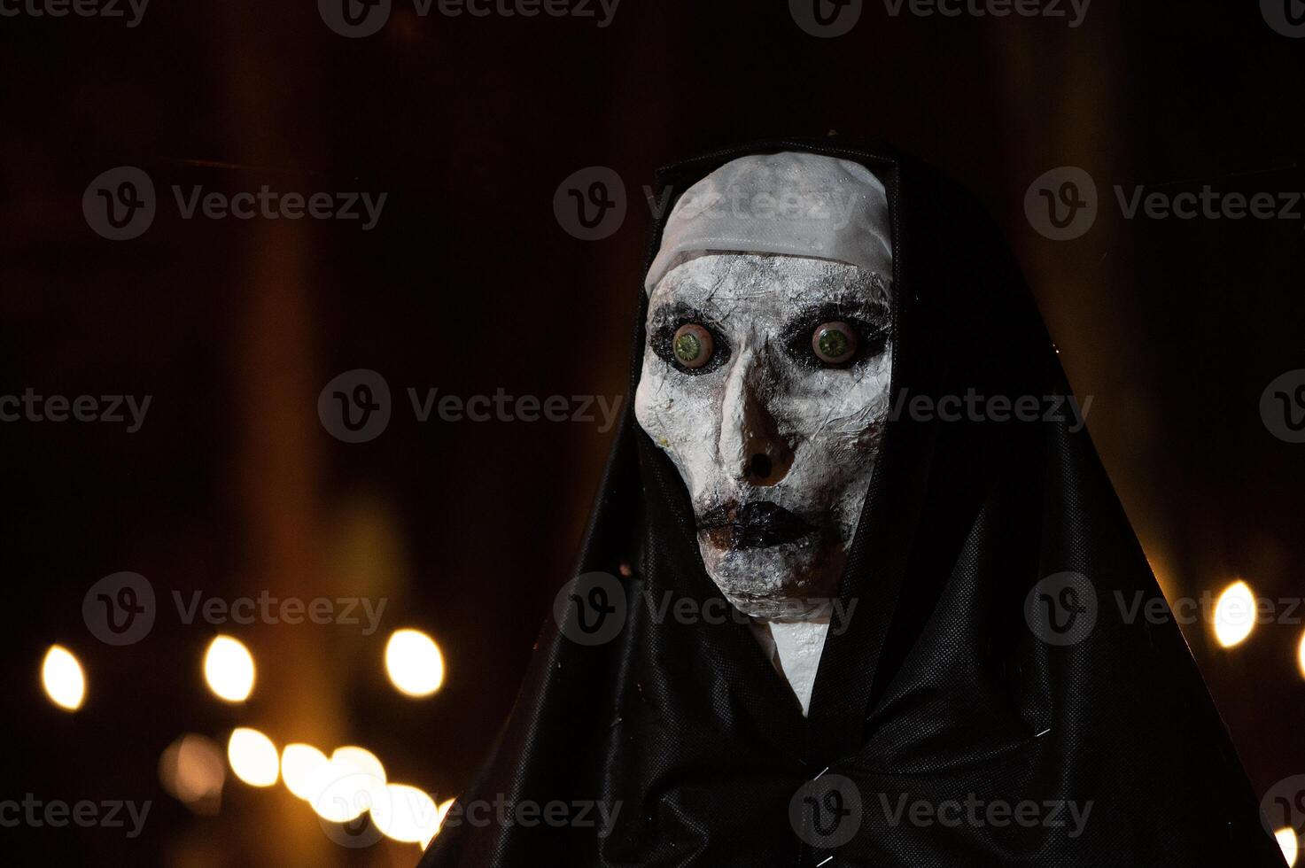 Spooky Halloween decoration stands in a wooded area creating a sinister atmosphere photo