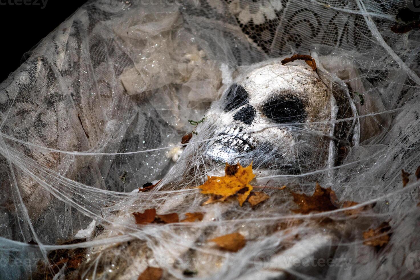 Spooky Halloween decoration stands in a wooded area creating a sinister atmosphere photo