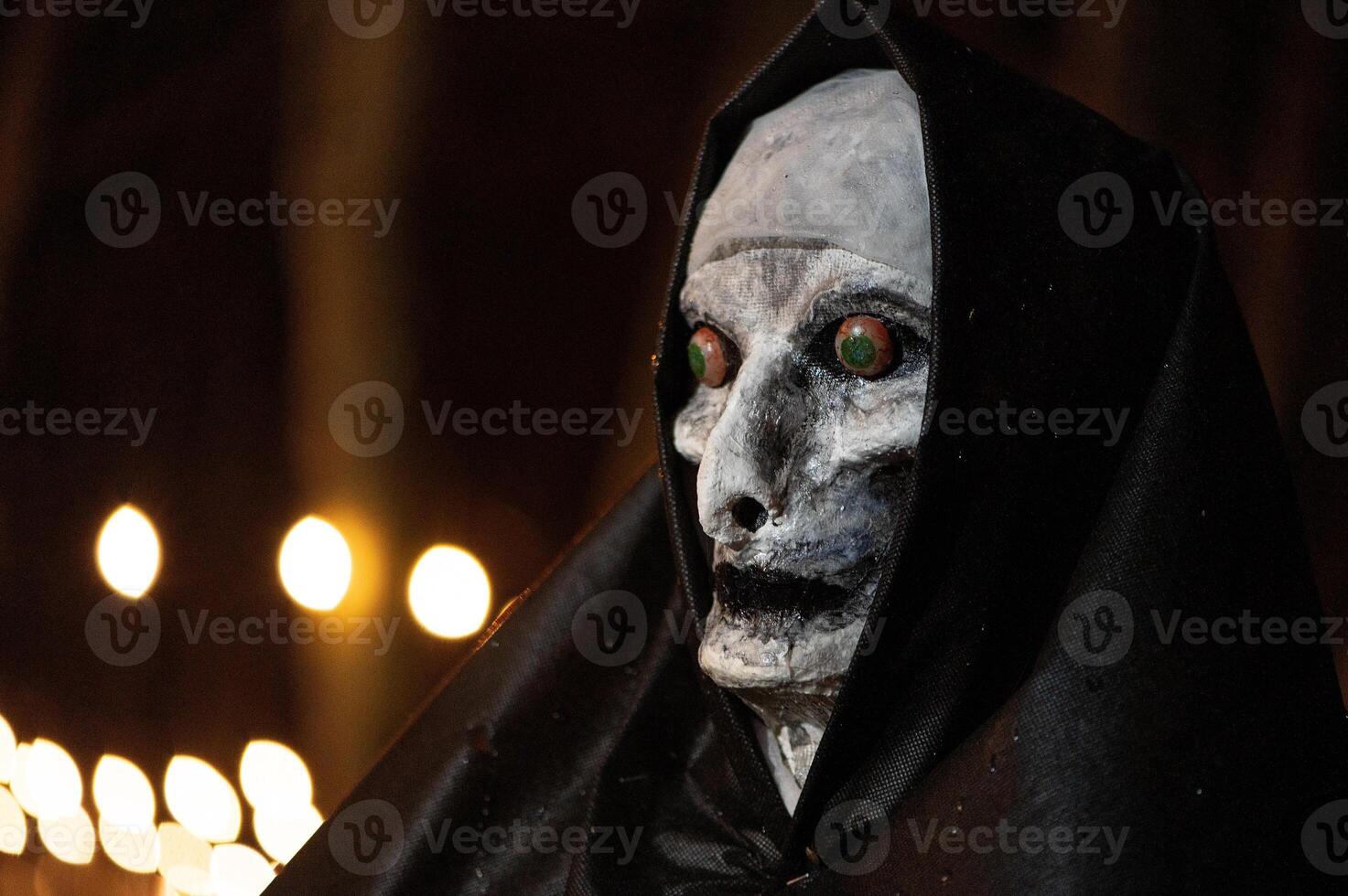 Spooky Halloween decoration stands in a wooded area creating a sinister atmosphere photo