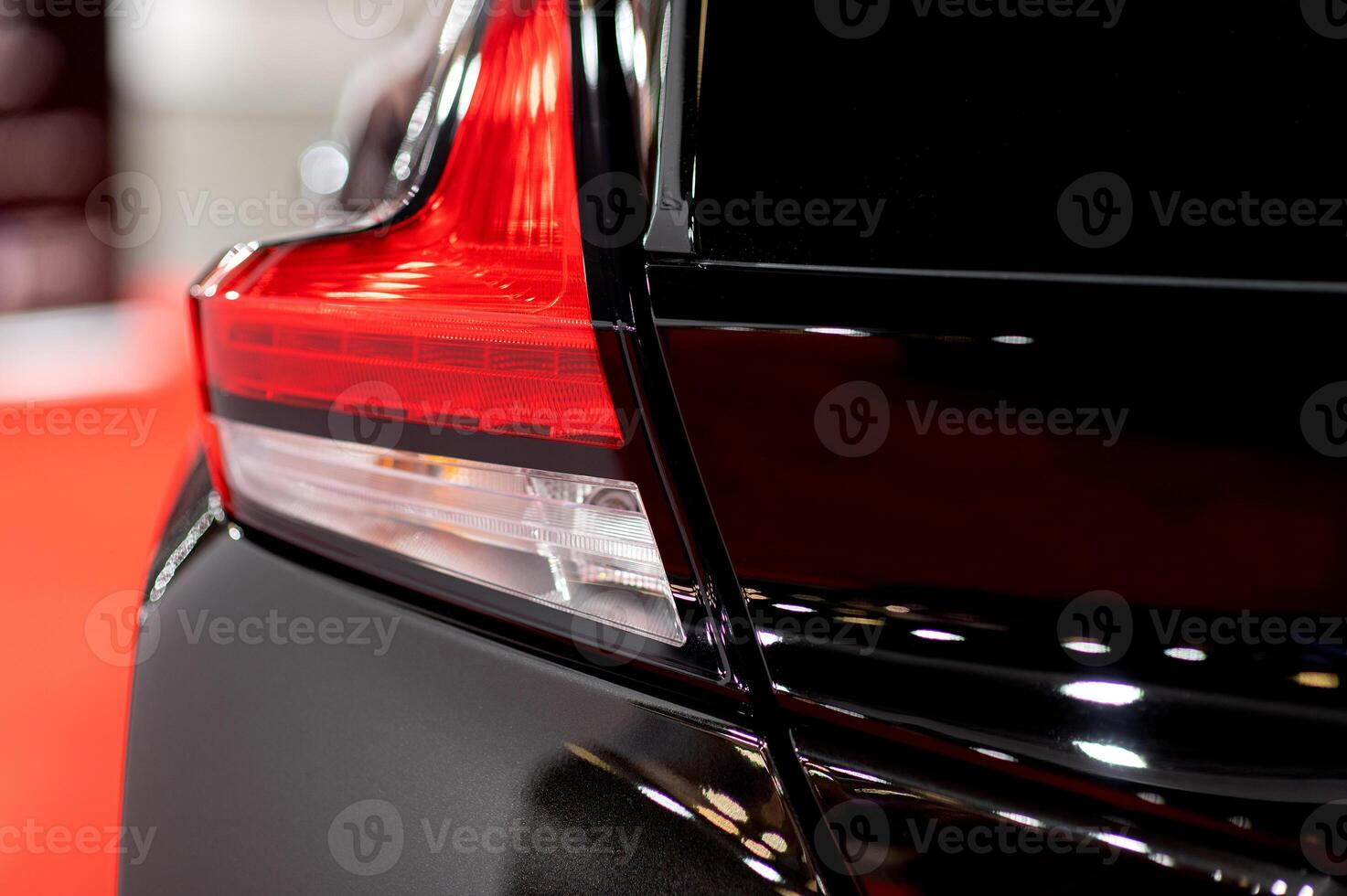 Red illuminated LED taillight on the back of a car at night photo