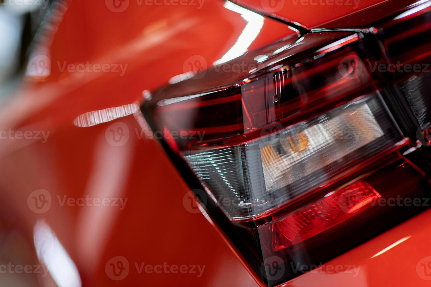Red illuminated LED taillight on the back of a car at night photo