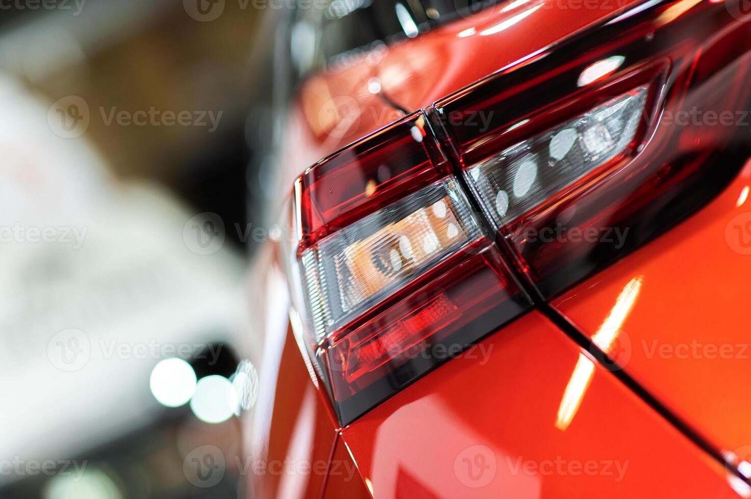 Red illuminated LED taillight on the back of a car at night photo