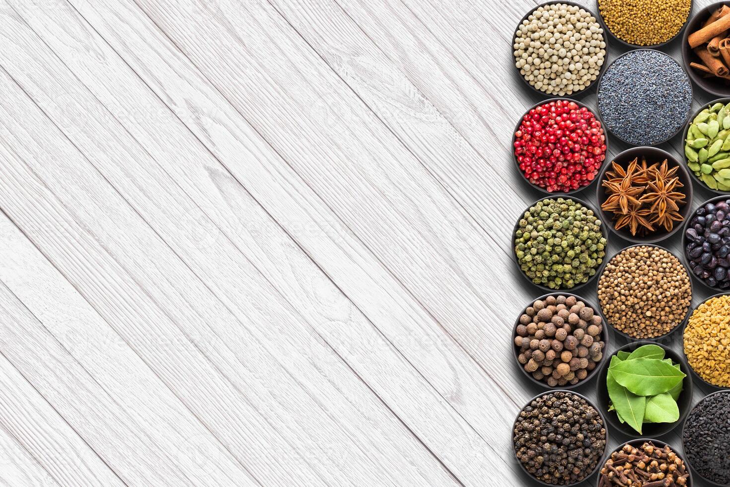 colored spices on a white table with empty space photo
