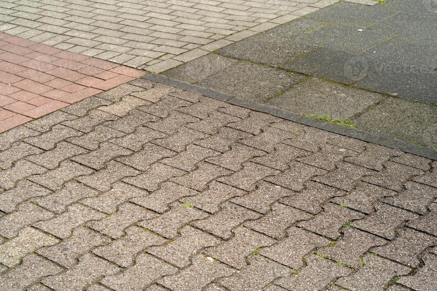different paving stones on the sidewalk photo