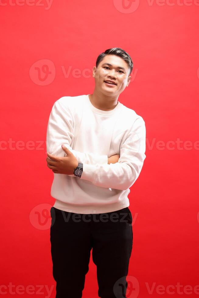Asian adult smiling man wearing white sweater standing with arms crossed. for fashion content, advertising, business photo