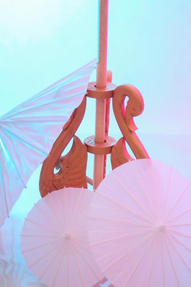 the beauty of umbrella decorations and swan motif stands from the side for the modern Javanese traditional bridal pre-wedding concept indoor studio for advertising, beauty, fashion, art content photo