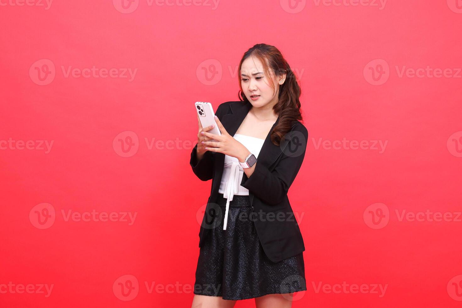 gesture of young asian career girl annoyed wearing black formal suit hand operating smartphone cellphone, for technology content, business, advertising, finance photo