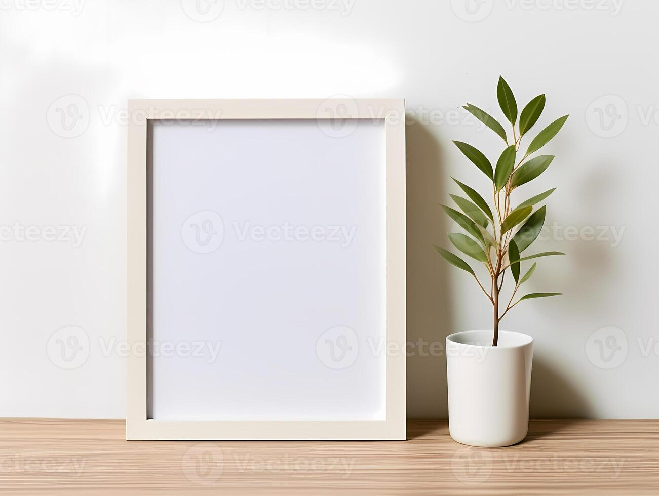 Minimalistic white picture frame and potted plant on wooden surface against plain background photo