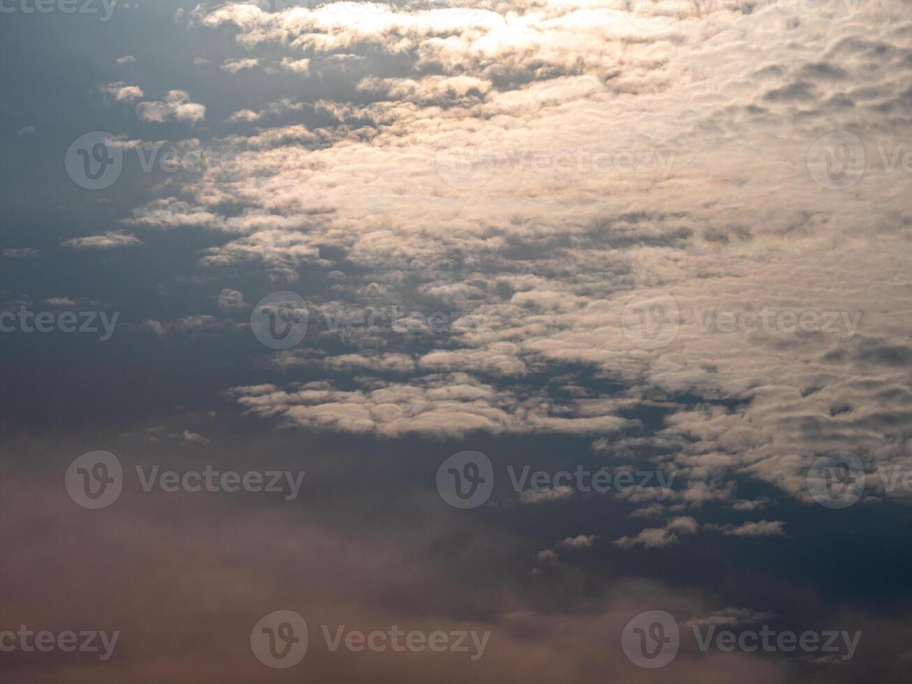 Fluffy clouds floating scattered across the sky photo