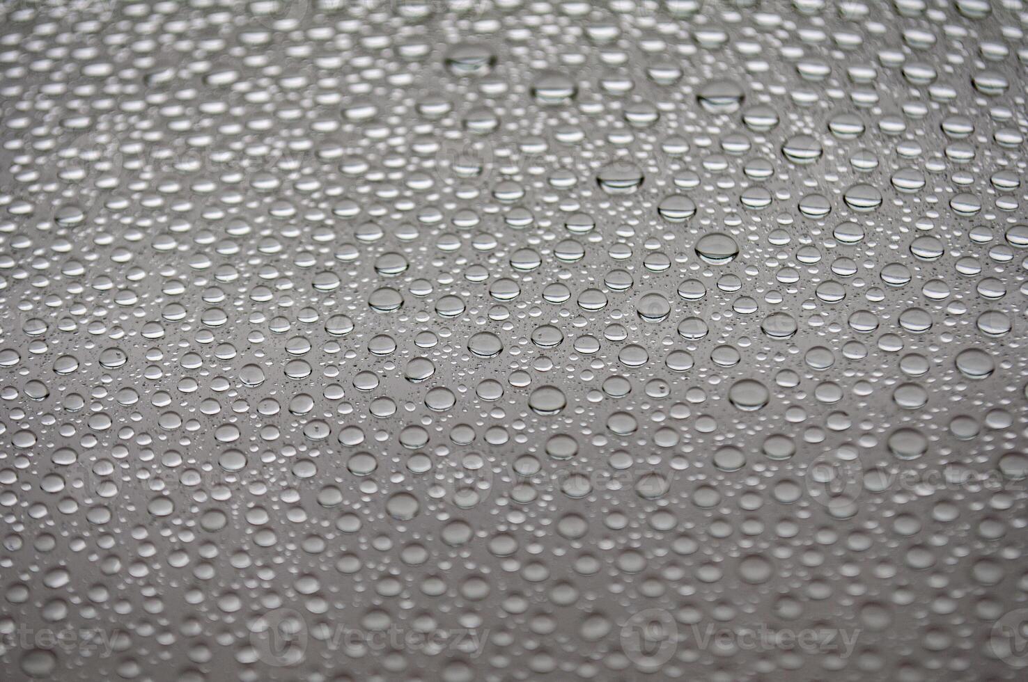 Water droplets on clear glass suitable for design and wallpaper photo
