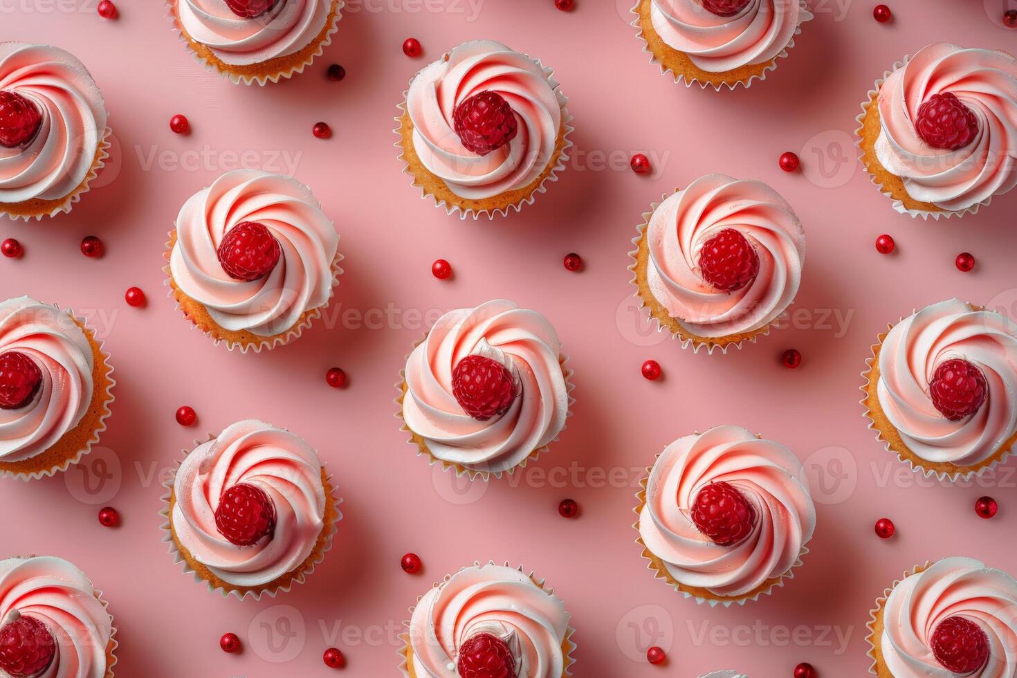 Cupcakes With White Frosting and Raspberries on Pink Surface photo