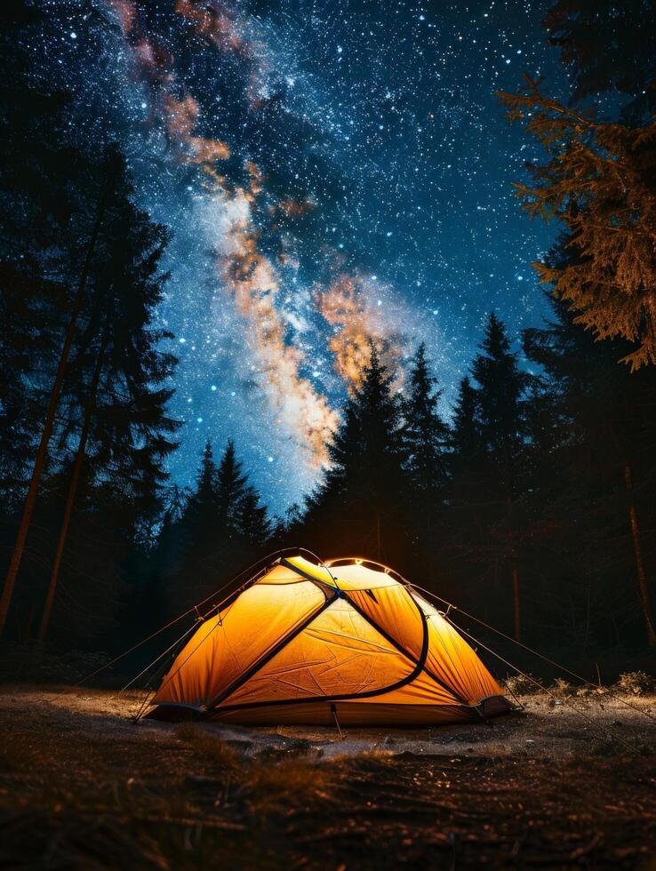 A Tent Pitched Up in the Middle of a Forest Under a Night Sky Filled With Stars photo