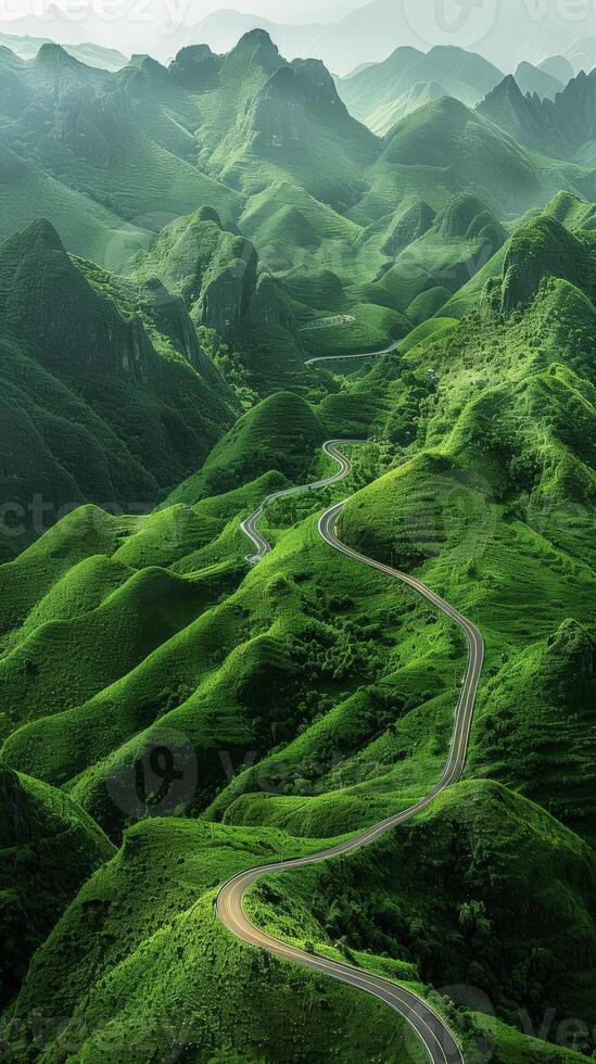 A road winding through a lush green valley photo