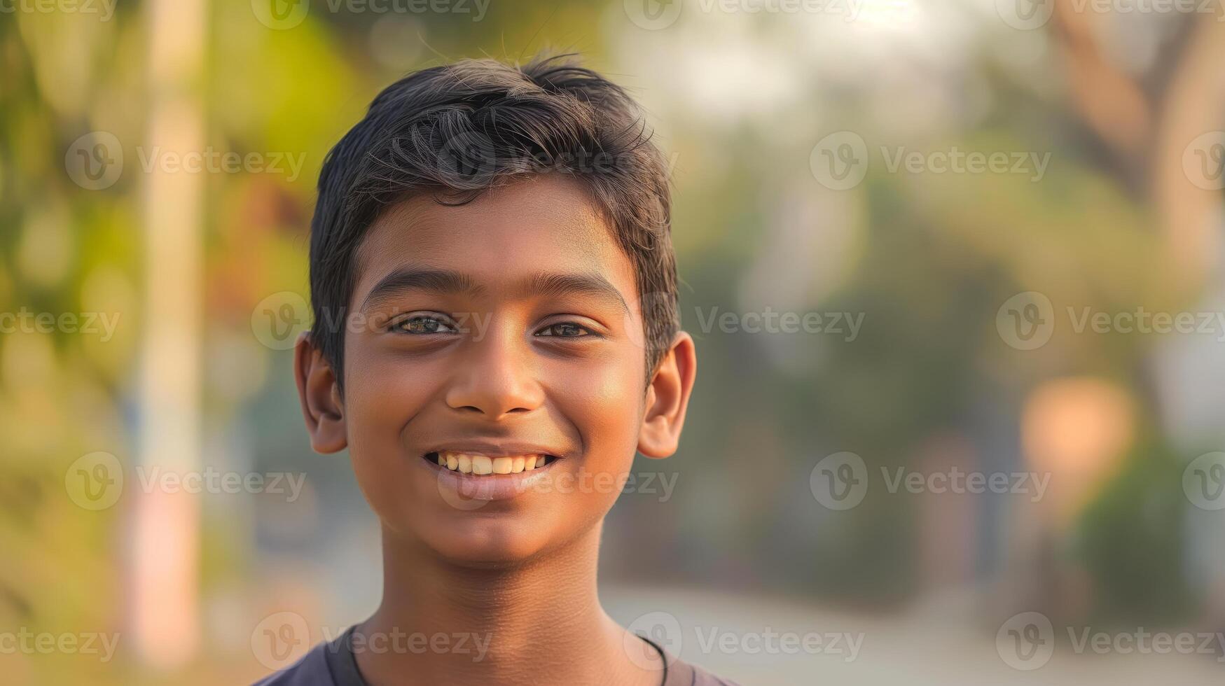Smiling Bangladeshi Teenage Boy Outdoors in a Natural Setting Stock Photography for Diversity and Youth Concepts photo