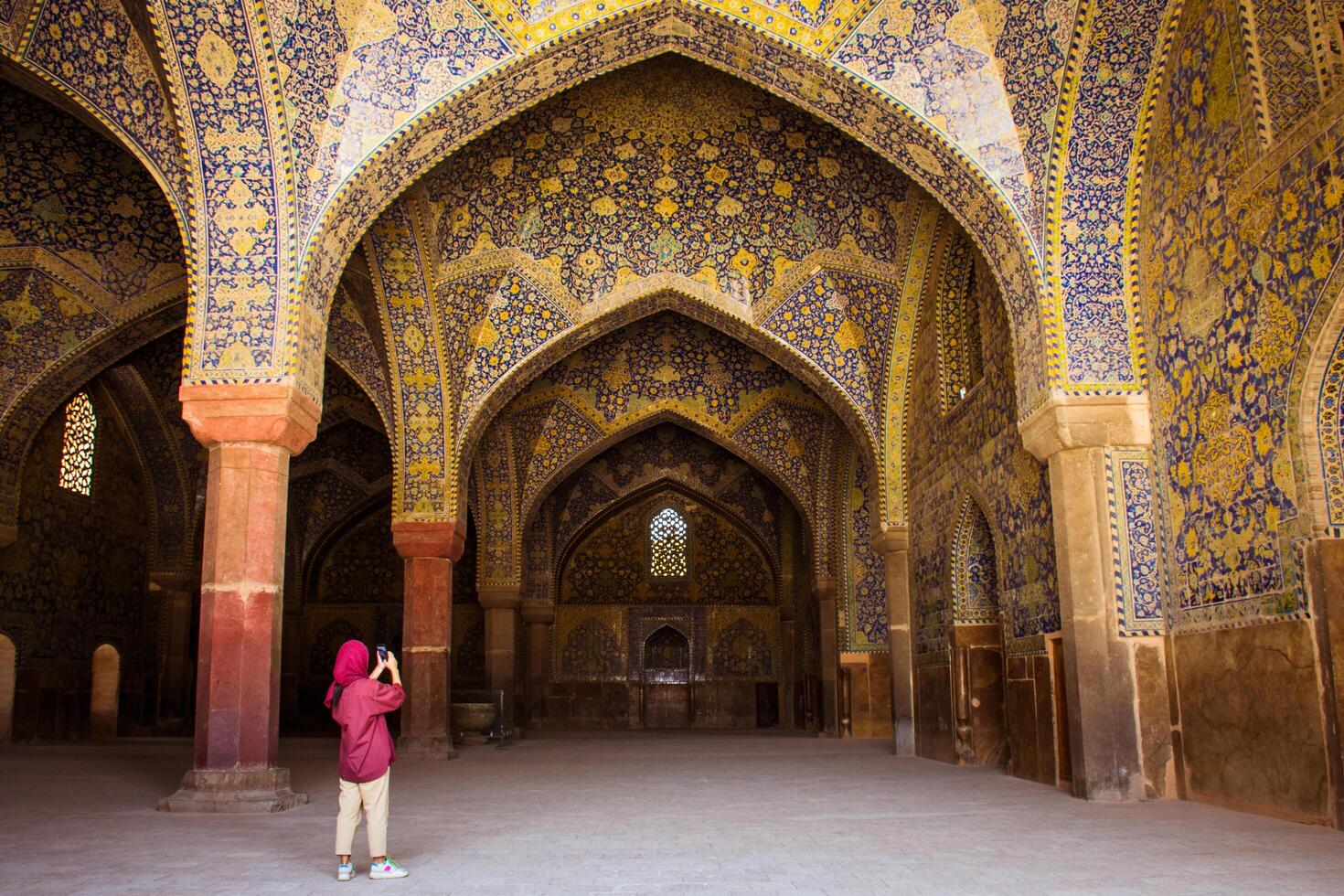 Isfahan, Iran - 15th may, 2022 - female tourist explore courtyard Friday Mosque, Jame Mosque Of Isfahan photo