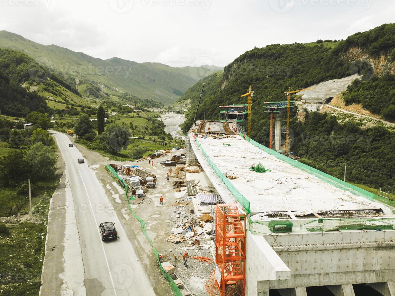 Kazbegi, Georgia - 7th july, 2024 - aerial view cranes and bridge foundation pillars on construction site of new highway road project built by chinese builders.Avalanche bypass tunnel.Tbillisi - Lars photo