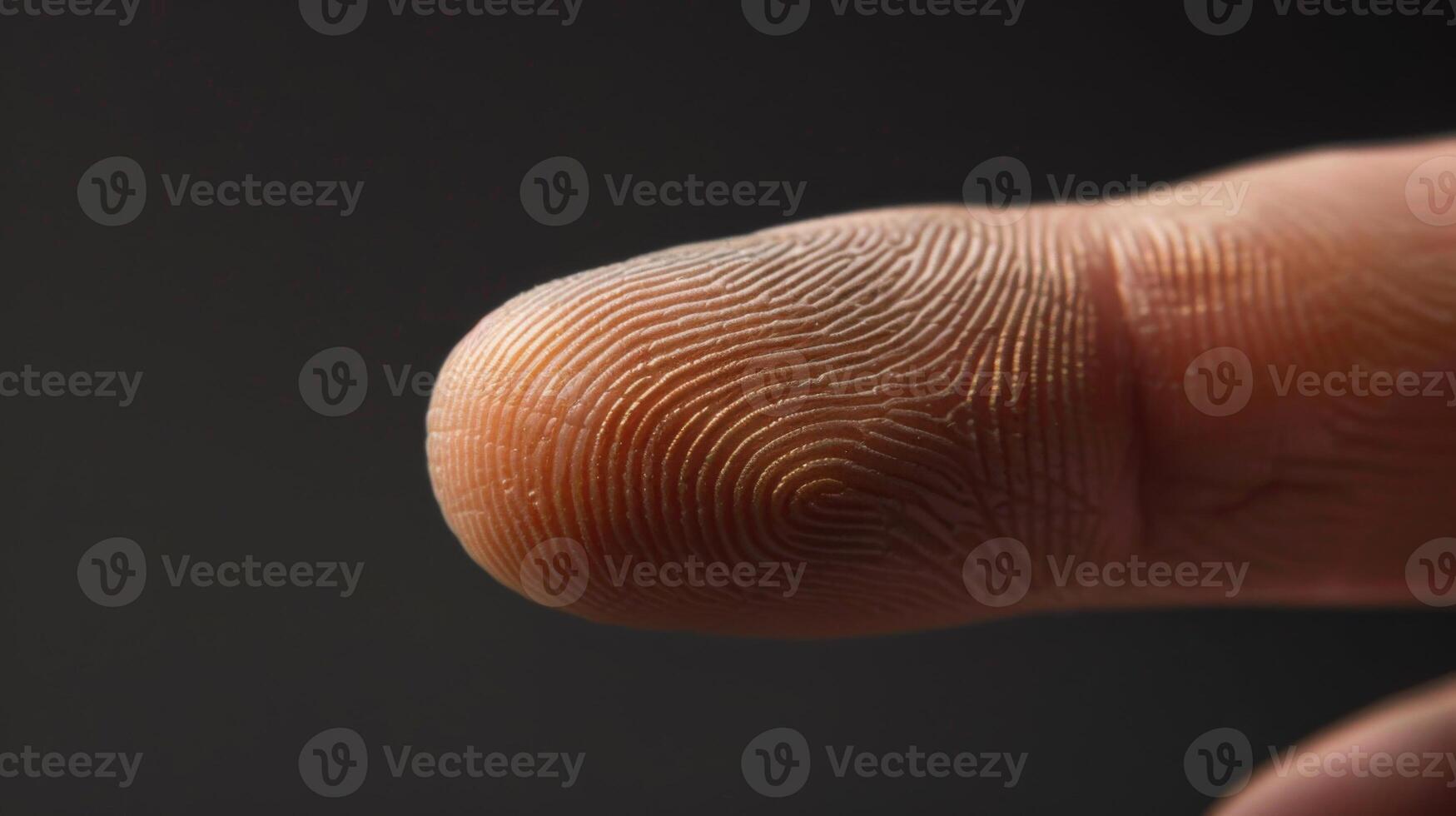 Finger with friction ridges on dark background, macro view photo