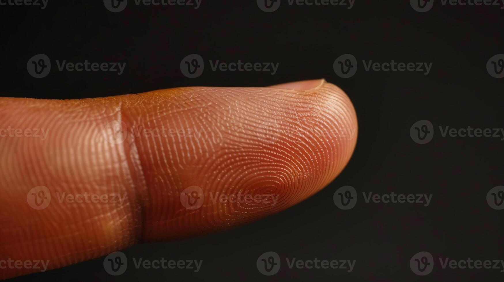 Finger with friction ridges on dark background, macro view photo
