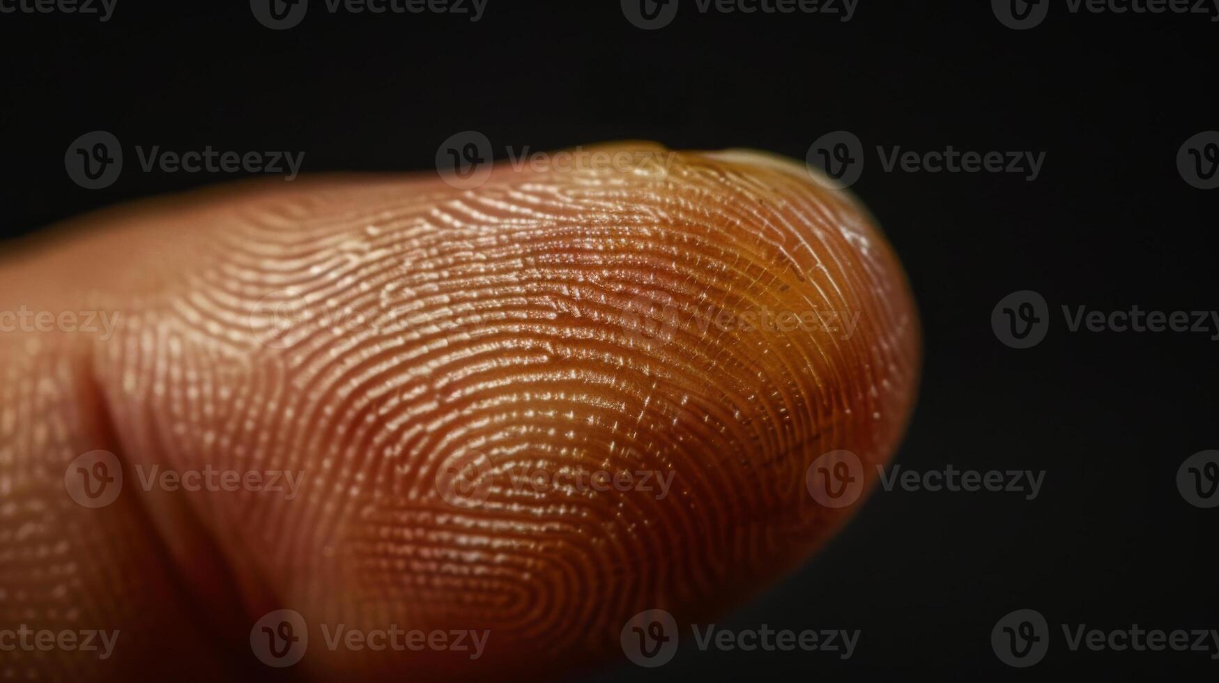 Finger with friction ridges on dark background, macro view photo