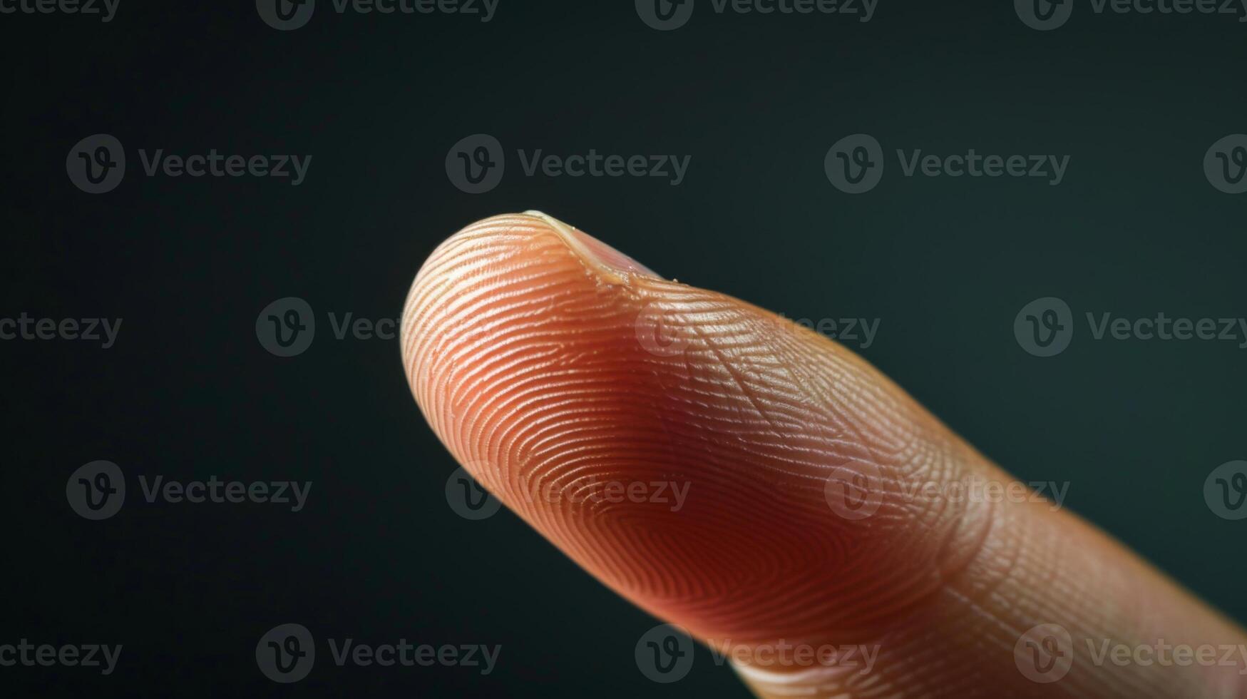 Finger with friction ridges on dark background, macro view photo