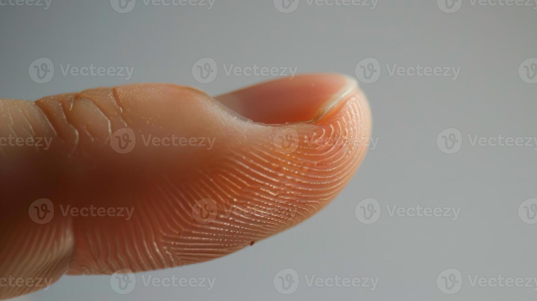Finger with friction ridges on dark background, macro view photo
