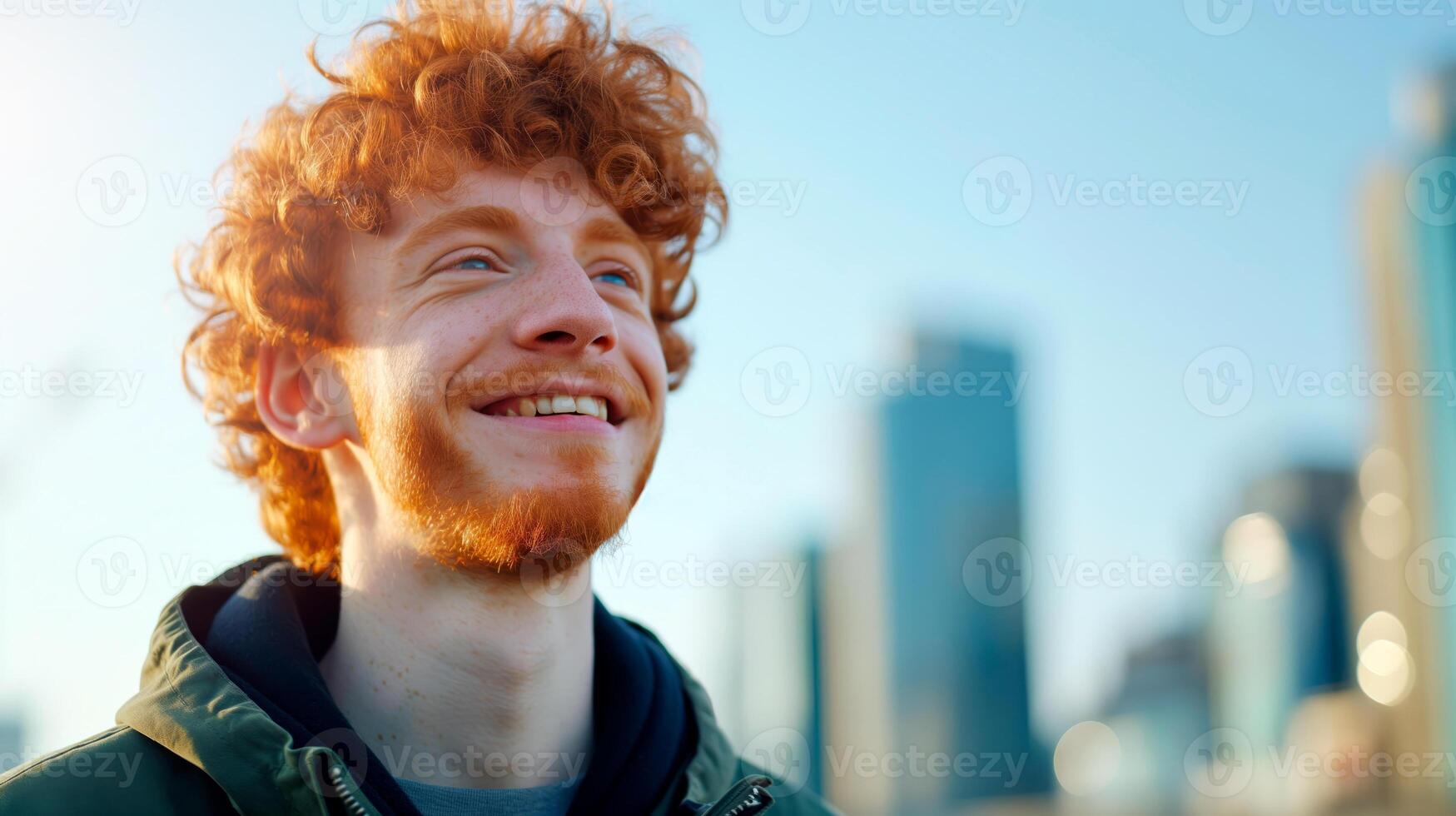Handsome smiling ginger man portrait on the street. photo